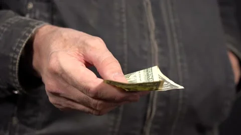Show One Dollar. A Man's Hand Holds One Dollar. Demonstrate Your Failure Stock Footage 147980854