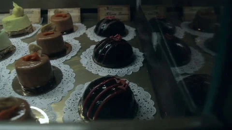 Showcase of cakes, pastry in window display Stock Footage 73769913