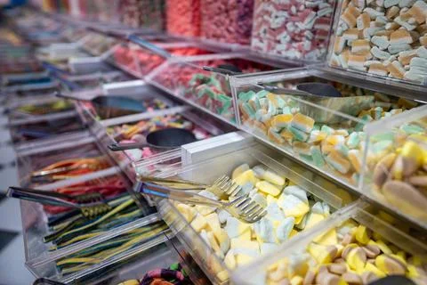 Showcase of candy shop, transparent container with various sweets, marshmallow Stock Photos