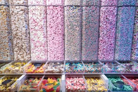 Showcase of candy shop, transparent container with various sweets, marshmallow Stockfoto's
