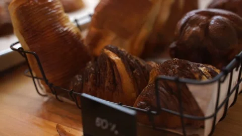 Showcase in the confectionery studio. Basket with pastries at a 50 discount. Stock Footage 219619670