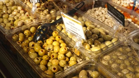 Showcase display of different olives at a covered market in the city center Stock Footage 284957298