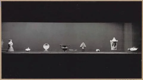 Showcase with eight objects including a oil lamp and left a vase in the fo... Stock Photos