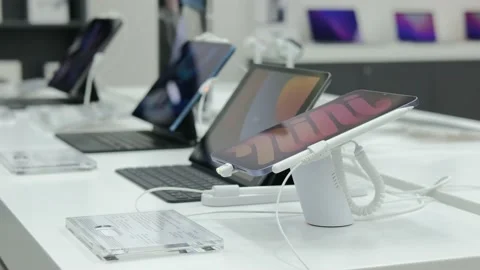 Showcase of an electronics store with a large selection of tablets of different Stock Footage 201236742