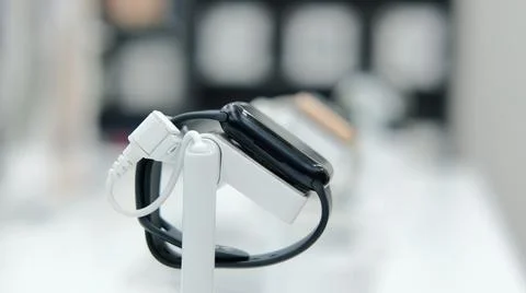 Showcase of an electronics store with a large selection of smart watches and Stock Photos