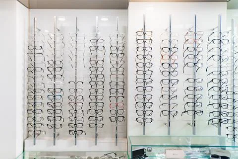 Showcase with glasses in different frames in the optics store. Stock Photos