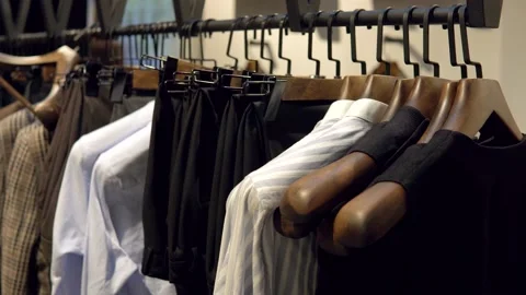 Showcase with jackets from the new collection in the luxury boutique of men's Stock Footage 144885960