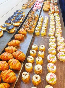 A showcase with a large selection of doughnuts and cakes Stock Photos