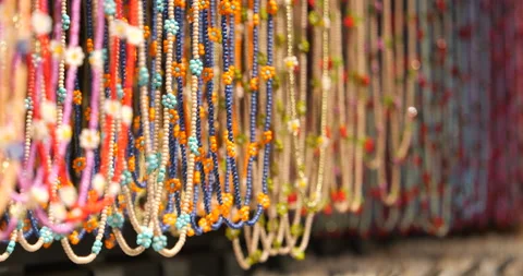 Showcase with multi-colored beads and different necklaces made of natural Stock Footage 223360532