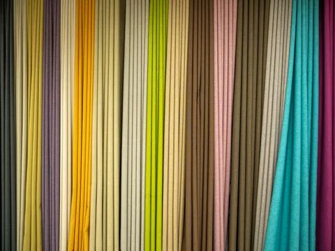 Showcase of multi-colored samples of natural fabrics. Stock Photos