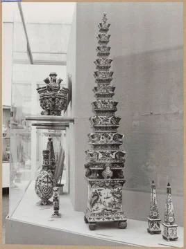 Showcase with objects of ceramics, including a flower pyramid and two obel... Stock Photos
