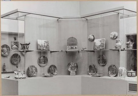 Showcase with objects of ceramics, including plates, a violin, two plates,... Stock Photos