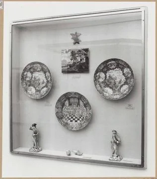 Showcase with objects of ceramics, including two mules of faience; Vitters... Stock Photos
