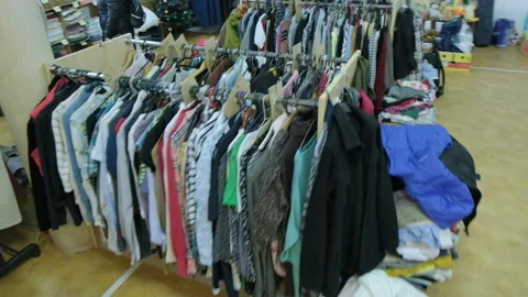 Showcase with a second-hand hanger. Humanitarian aid warehouse. 스톡 동영상 168291068