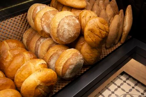 Showcase shelf with round breads in bakery Stock Photos