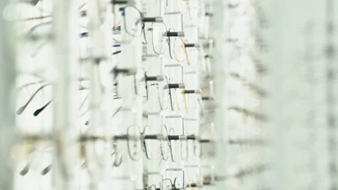 Showcase with spectacles in modern ophthalmic store. Glasses on display on wall Stock Footage 231674737