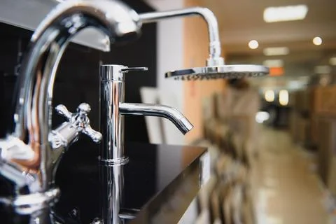 Showcase in the store with faucets for the kitchen and bathroom Stock Photos