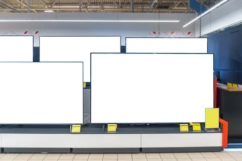 A showcase with televisions in an electronics store. Buying a modern large-sc Stock Photos