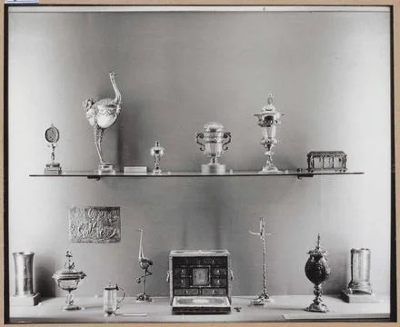 Showcase with various metal objects including a box with drawers and two n... Stock Photos