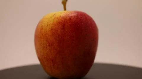 Showcases a vibrant red apple with stunning texture and color against a simple b Stock Footage 328634281
