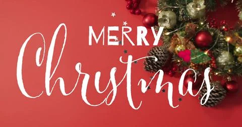 Showcasing large white hand-lettered Christmas text sitting on red backdrop, Stock Photos