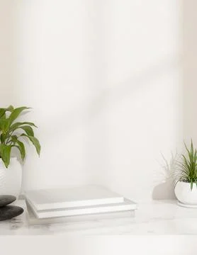 A showcasing space on a stack of books on a white tabletop featuring stones.. Stock Photos