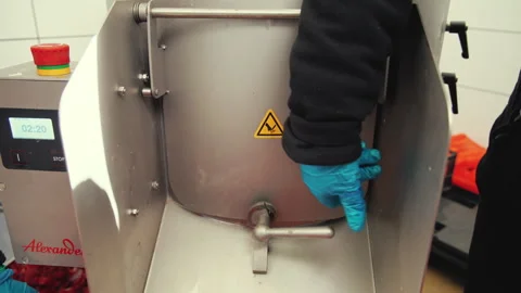 Showcasing a vegetable processing machine at work. Peeled beets falling out of Stock Footage 246424444
