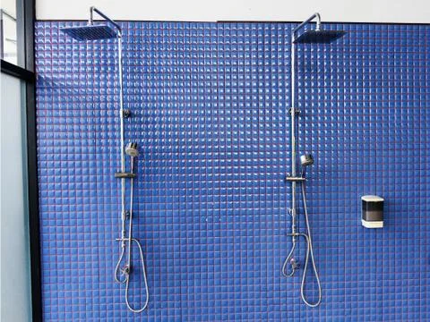 Shower on blue tile wall Stock Photos