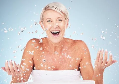 Shower, face and old woman excited with water drops, clean skin and antiaging Stock Photos