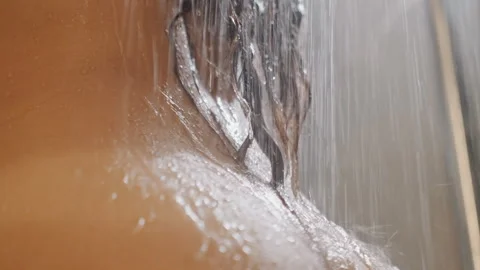 Shower foam rinse. Spa guest cleansing with soap and water in bathroom. Business Video stock 330533727
