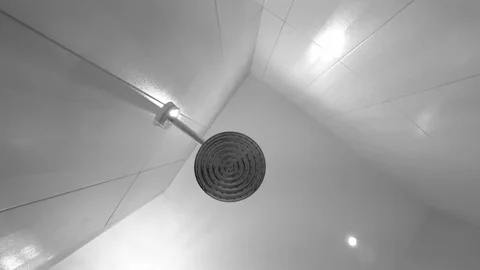 Shower head in bathroom. Falling water drops. Black and white. Stock Footage 83428673