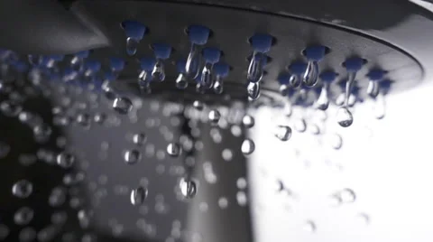 Shower head in bathroom with water drops flowing. Slow motion Stock Footage