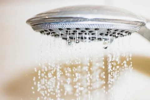 Shower head with drops of water falling down Stock Photos