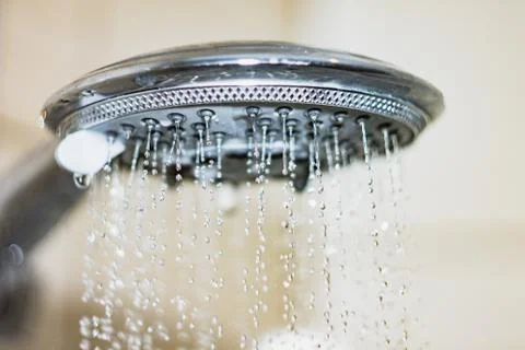 Shower head with drops of water falling down Stock Photos
