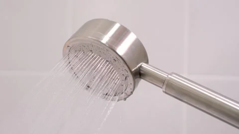 Shower head on gray tile background close-up, side view. Stock Footage 311791443