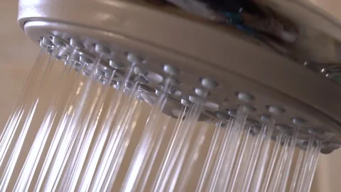 Shower head, macro view. Water drips, pours a stream into the bath. New showe Stock Footage 173408163