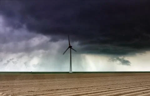 Shower rain cloud over windmill Stock Photos