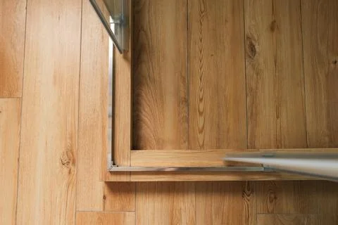 Shower stall threshold. The floor is made of wood-look tile and the shower is Stock Photos