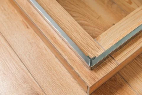 Shower stall threshold. The floor is made of wood-look tile and the shower is Stock Photos