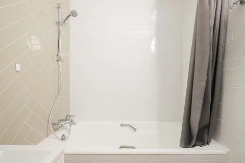 Shower system over the bath in the the bathroom Stock Photos