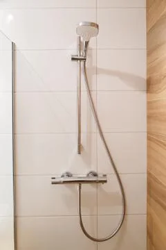 Shower on tile wall Stock Photos