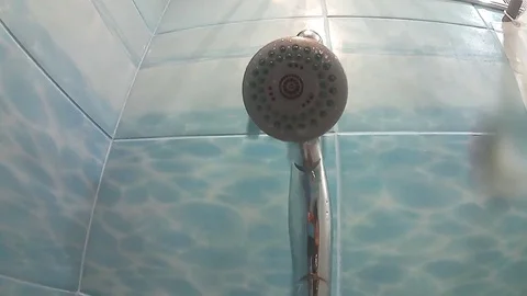 The shower turns on, the water flows to the camera. go pro Stock Footage 78147195