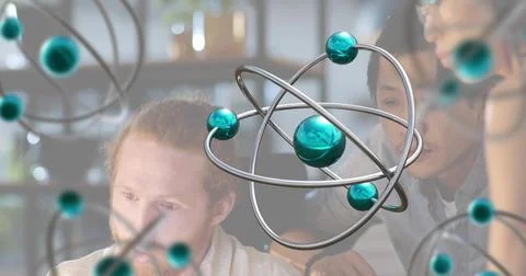 Showing 3D atom model in front while team discussing at desk with monitor, Stock Photos