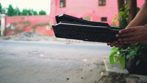 Showing broken keyboard recently smashed on concrete wall outdoor morning Stock Footage 138784145