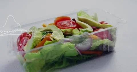 Showing clear plastic clamshell holding lettuce tomato avocado onion carrot on Stock Photos