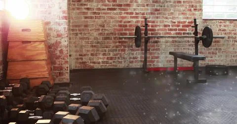 Showing cluster of hexagonal dumbbells sitting on left at garage gym corner, Stock Photos