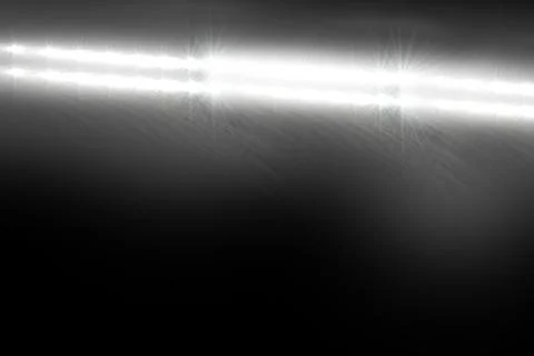 Showing flat design light beam emitting starburst flares and streaks in dark Illustrazione stock