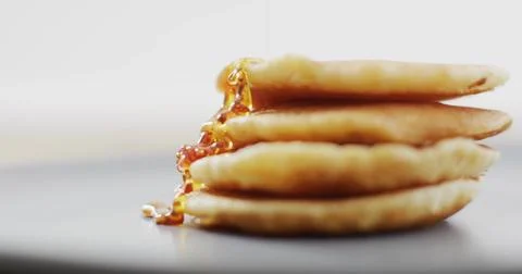 Showing four-pancake stack on table, amber syrup cascading, droplets forming, Stock Photos