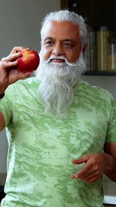 Showing fresh red apple to camera, Indian mid age man flexing muscle Stock-Footage 342756861