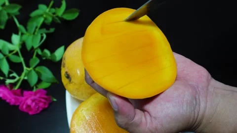 Showing hand of Man Cutting Mango into Cubes on Palm Tropical Fruit Preparation. Stock Footage 310973215
